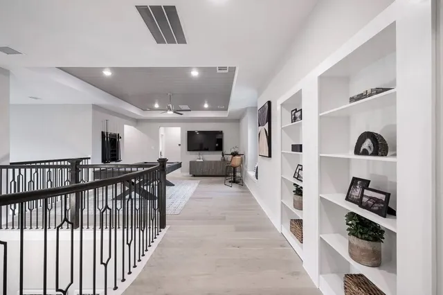 a view of a hallway with workspace and closet