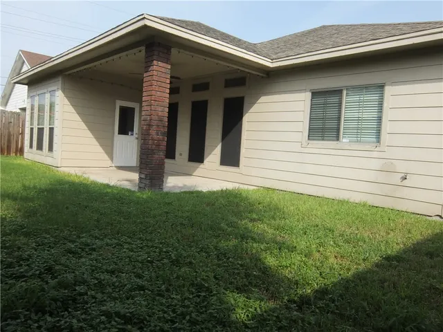 a view of house with backyard