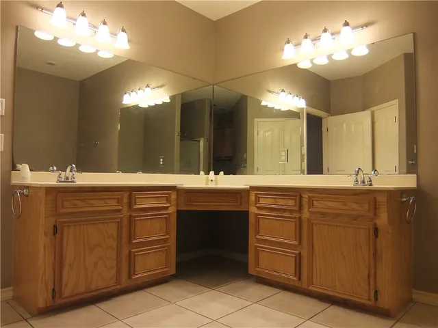 a bathroom with a sink vanity and a mirror