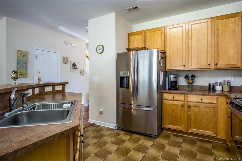 975 Copperstone Lane, Unit 975 Fort Mill, SC 29708 - Photo 13 of 23 a kitchen with a refrigerator sink and cabinets