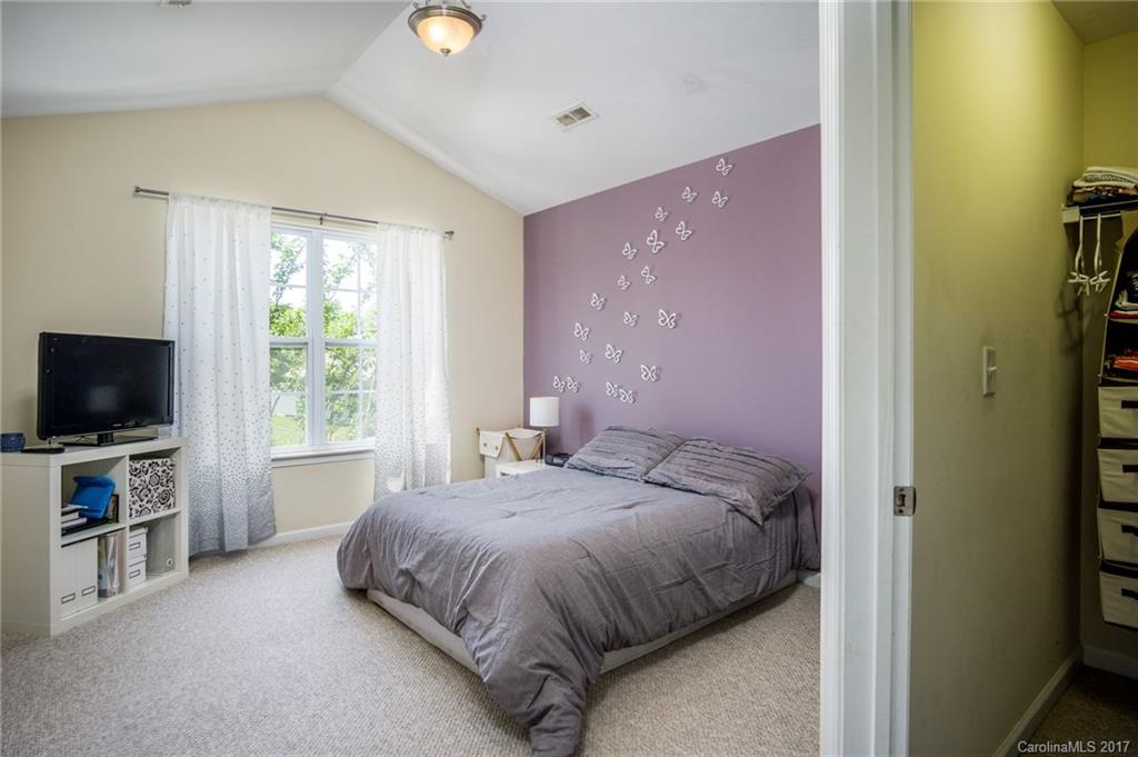 975 Copperstone Lane, Unit 975 Fort Mill, SC 29708 - Photo 17 of 23 a bedroom with a bed and a flat screen tv