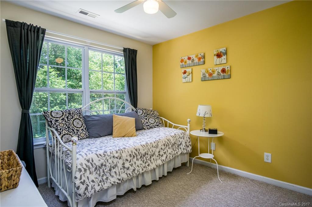975 Copperstone Lane, Unit 975 Fort Mill, SC 29708 - Photo 19 of 23 a living room with a couch and a chandelier