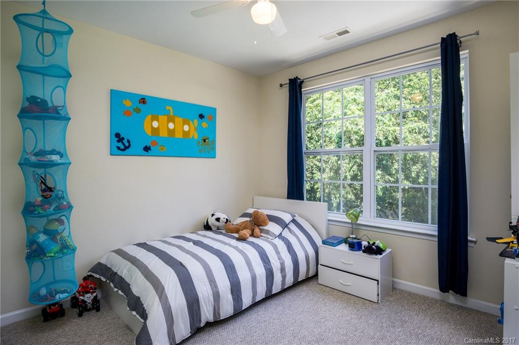 975 Copperstone Lane, Unit 975 Fort Mill, SC 29708 - Photo 20 of 23 a bed sitting in a bedroom next to a window