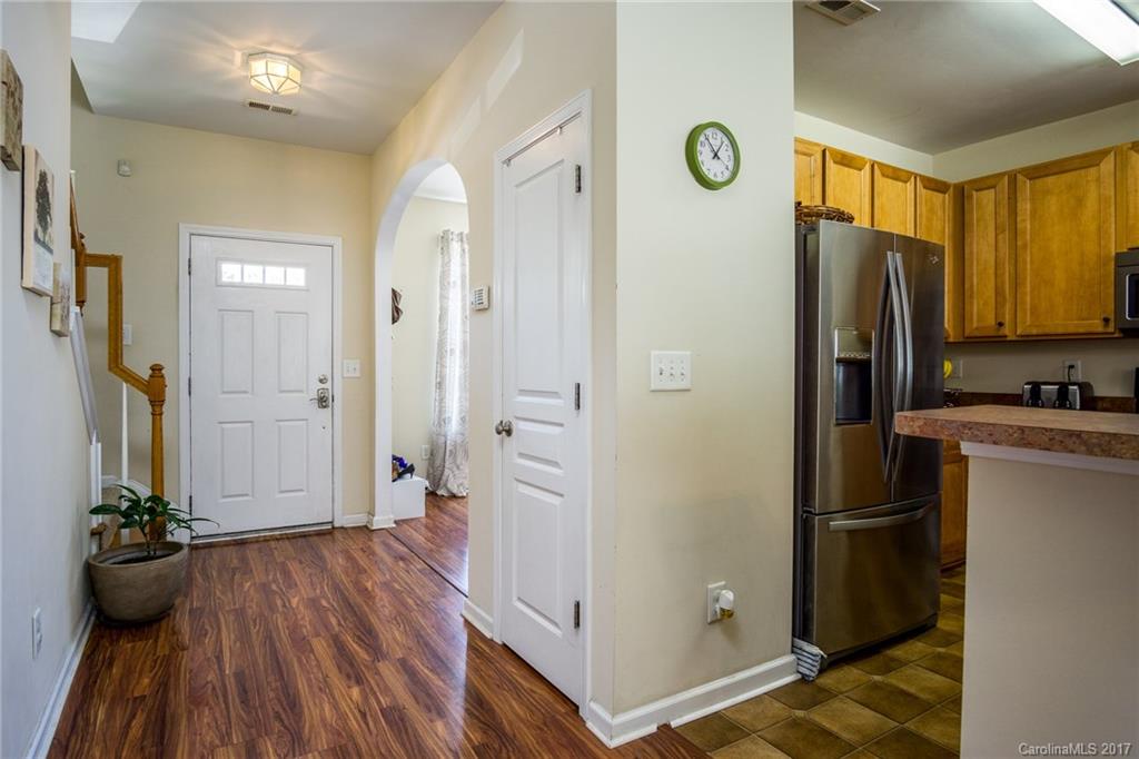 975 Copperstone Lane, Unit 975 Fort Mill, SC 29708 - Photo 4 of 23 a kitchen with a refrigerator and wooden floor