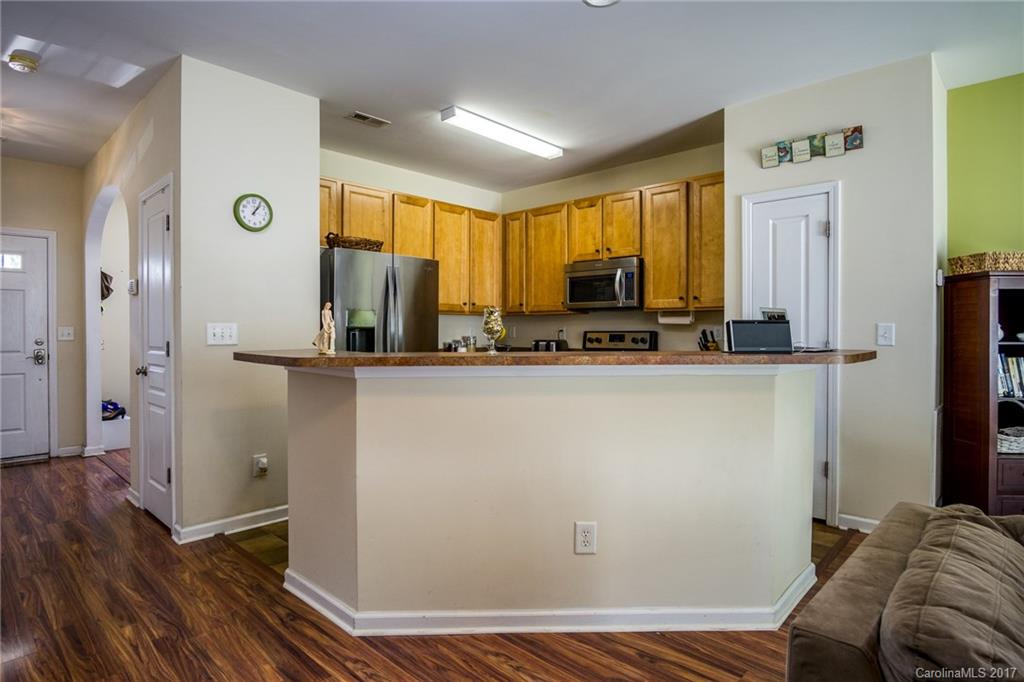 975 Copperstone Lane, Unit 975 Fort Mill, SC 29708 - Photo 9 of 23 a view of kitchen with furniture and wooden floor