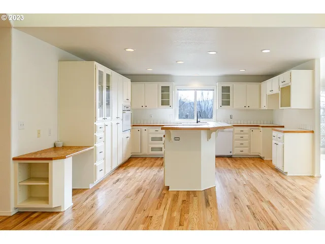 a kitchen with a cabinets and wooden floor