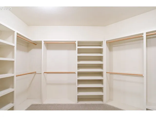 a view of closet area with empty racks