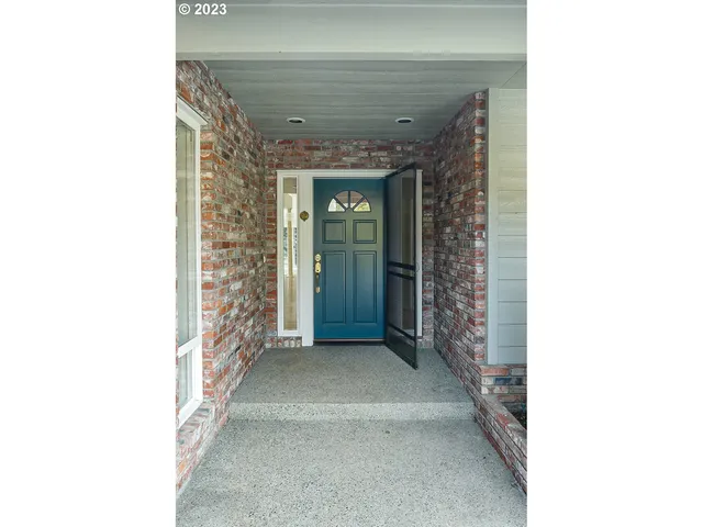 a view of a hallway with brick walls