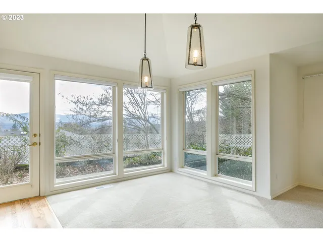 a view of an empty room with windows