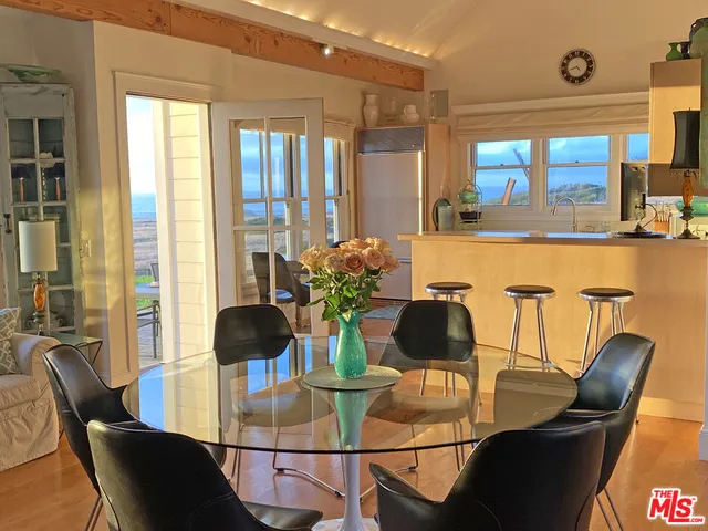 a living room with furniture and a dining table