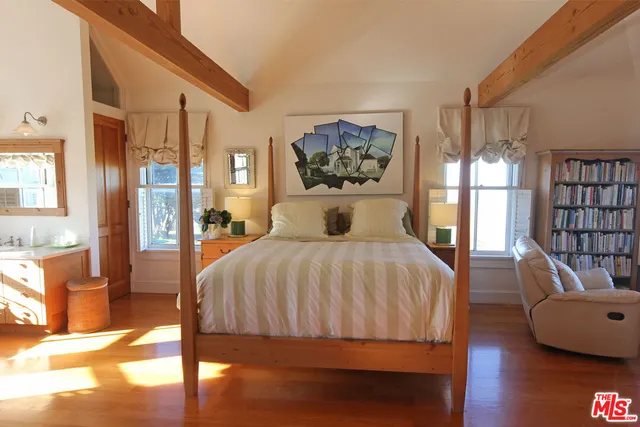 a spacious bedroom with a bed and large windows