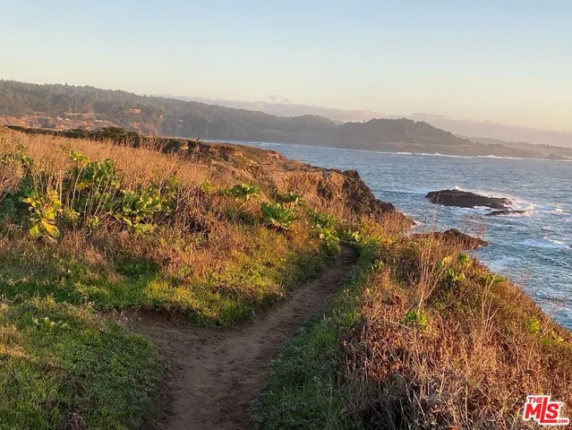 a view of ocean with mountain