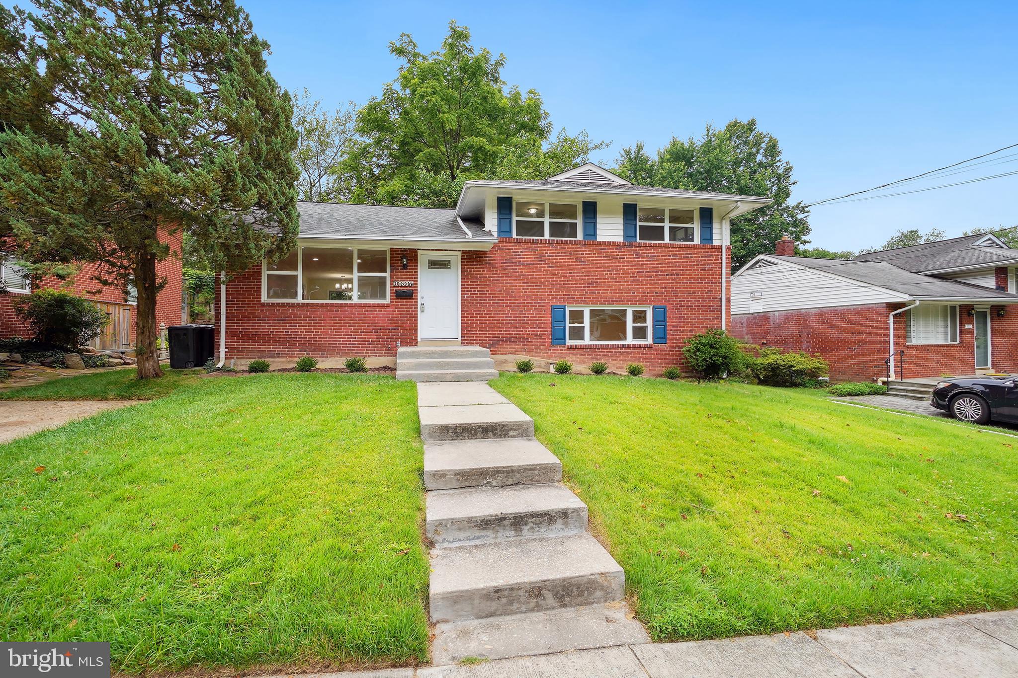 a front view of a house with a yard table and chairs