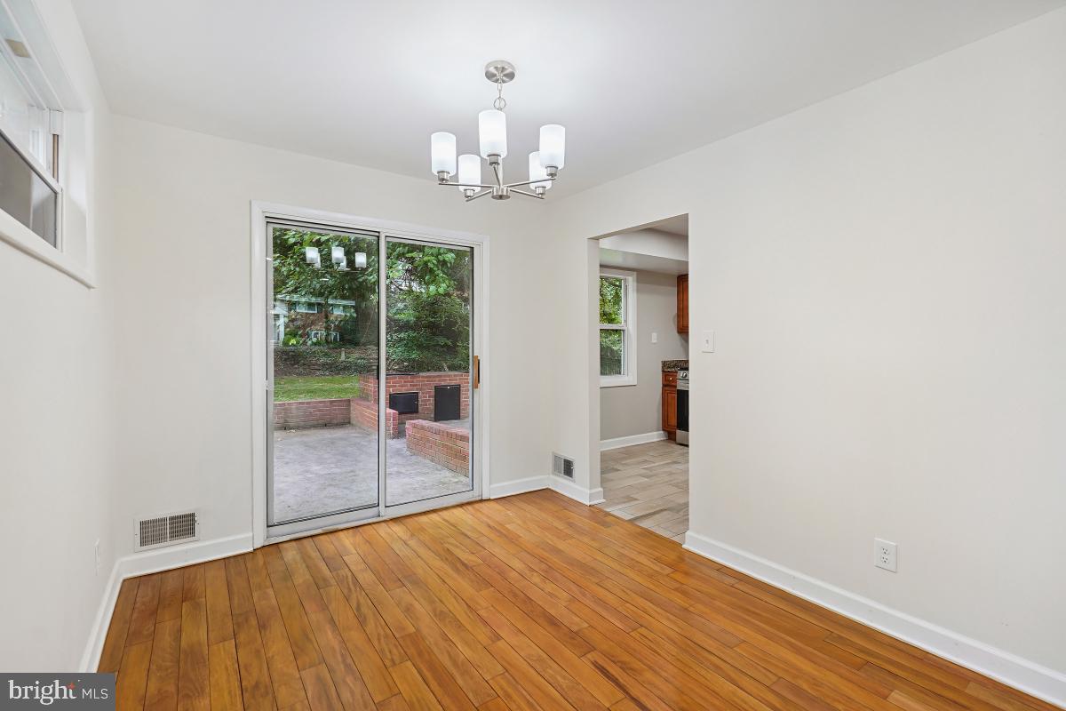 10307 Leslie Street Silver Spring, MD 20902 - Photo 11 of 46 wooden floor in an empty room with a window