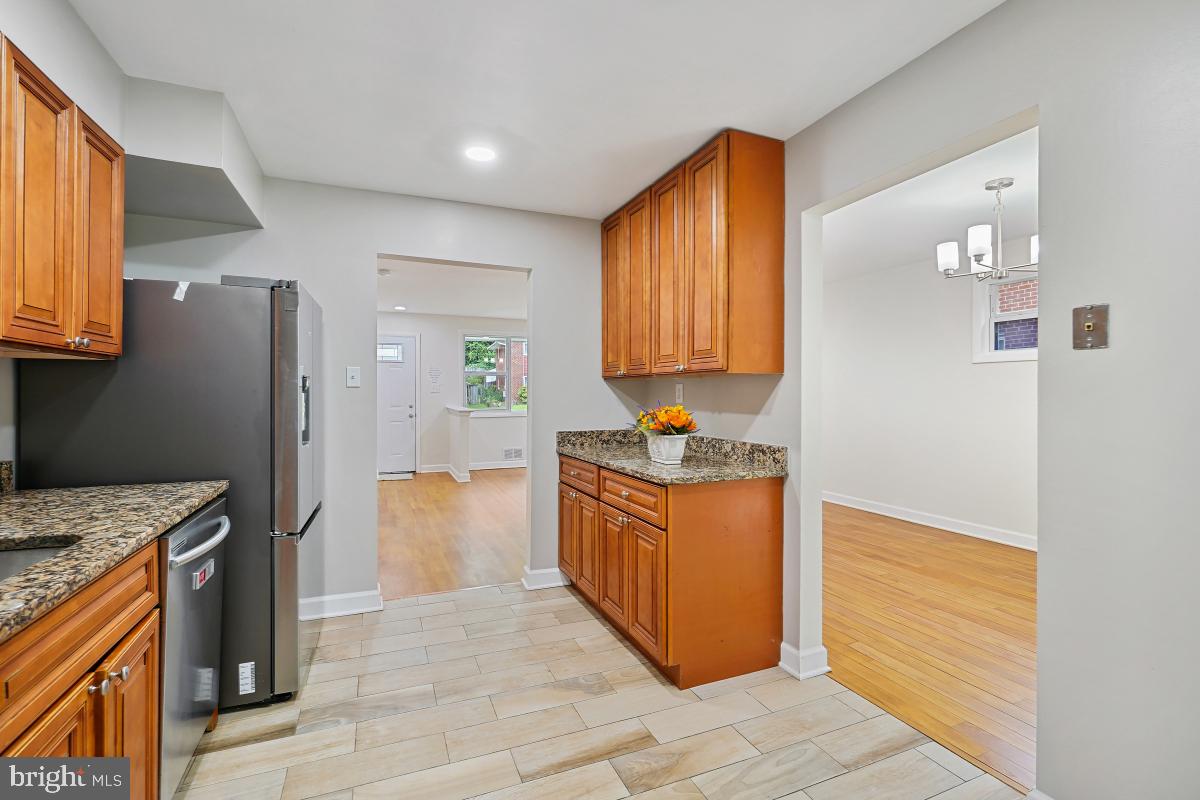 10307 Leslie Street Silver Spring, MD 20902 - Photo 17 of 46 a kitchen with granite countertop a sink and a refrigerator