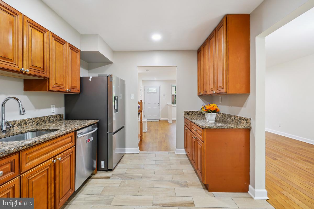 10307 Leslie Street Silver Spring, MD 20902 - Photo 18 of 46 a kitchen with stainless steel appliances granite countertop a refrigerator a stove and a sink