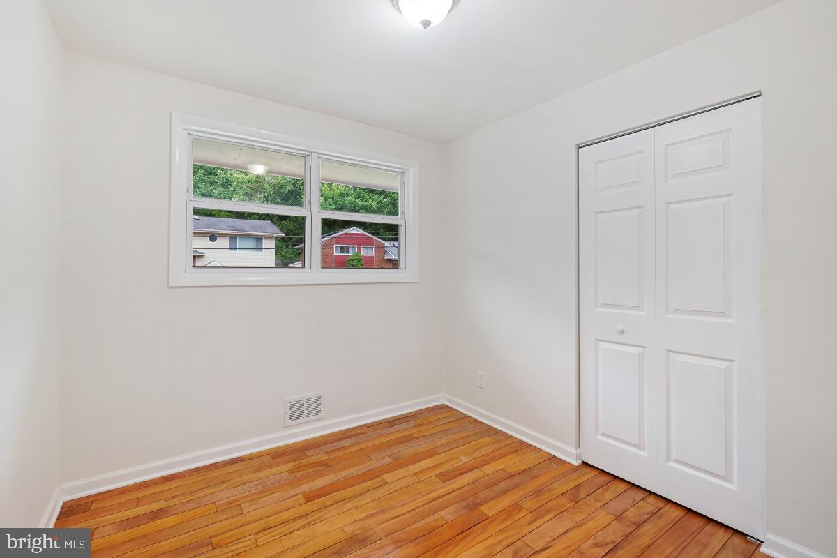 10307 Leslie Street Silver Spring, MD 20902 - Photo 21 of 46 a view of empty room with wooden floor and fan