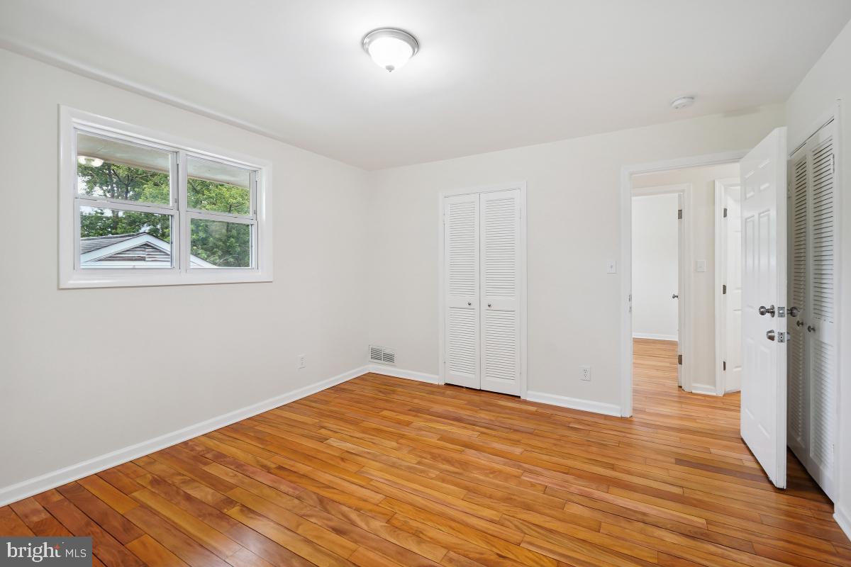 10307 Leslie Street Silver Spring, MD 20902 - Photo 27 of 46 a view of empty room with wooden floor and fan