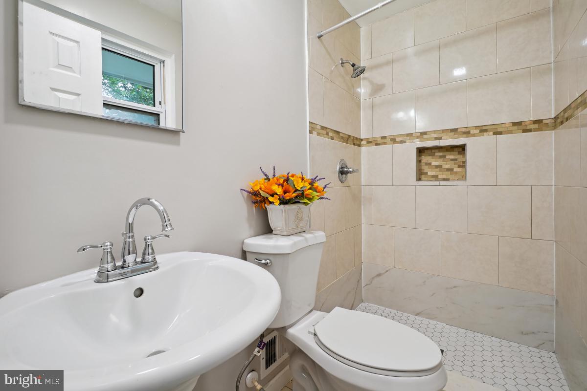 10307 Leslie Street Silver Spring, MD 20902 - Photo 28 of 46 a bathroom with a sink mirror and toilet