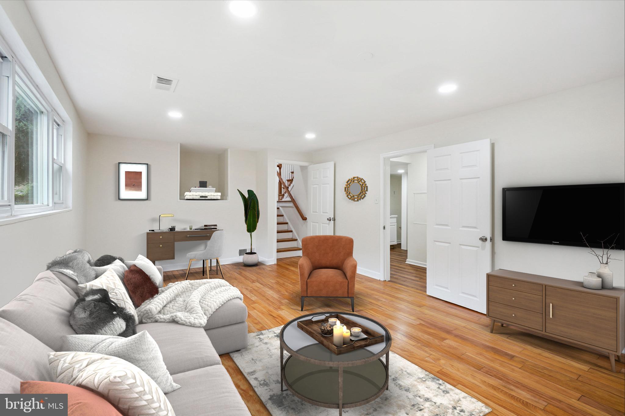 10307 Leslie Street Silver Spring, MD 20902 - Photo 30 of 46 a living room with furniture and a flat screen tv