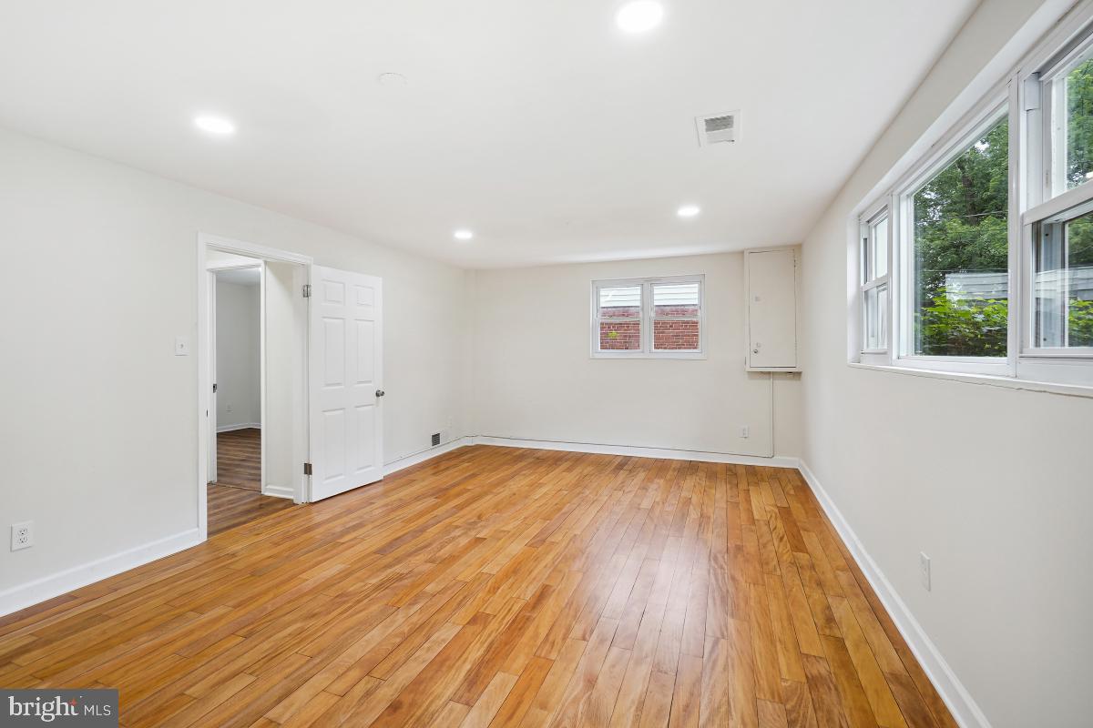 10307 Leslie Street Silver Spring, MD 20902 - Photo 33 of 46 a view of empty room with wooden floor and fan