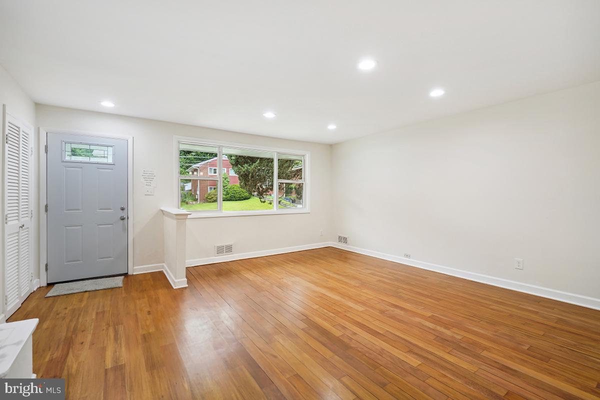 10307 Leslie Street Silver Spring, MD 20902 - Photo 6 of 46 an empty room with wooden floor and windows