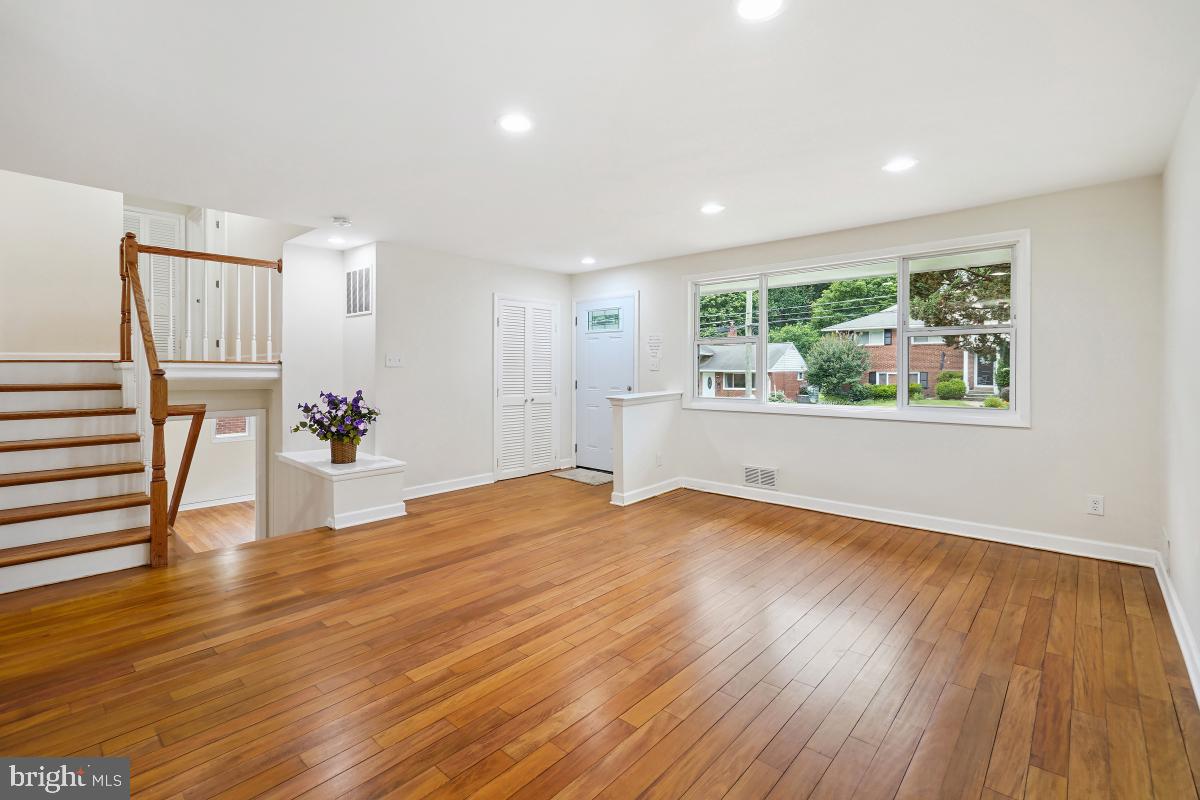 10307 Leslie Street Silver Spring, MD 20902 - Photo 7 of 46 a view of empty room with wooden floor and fan