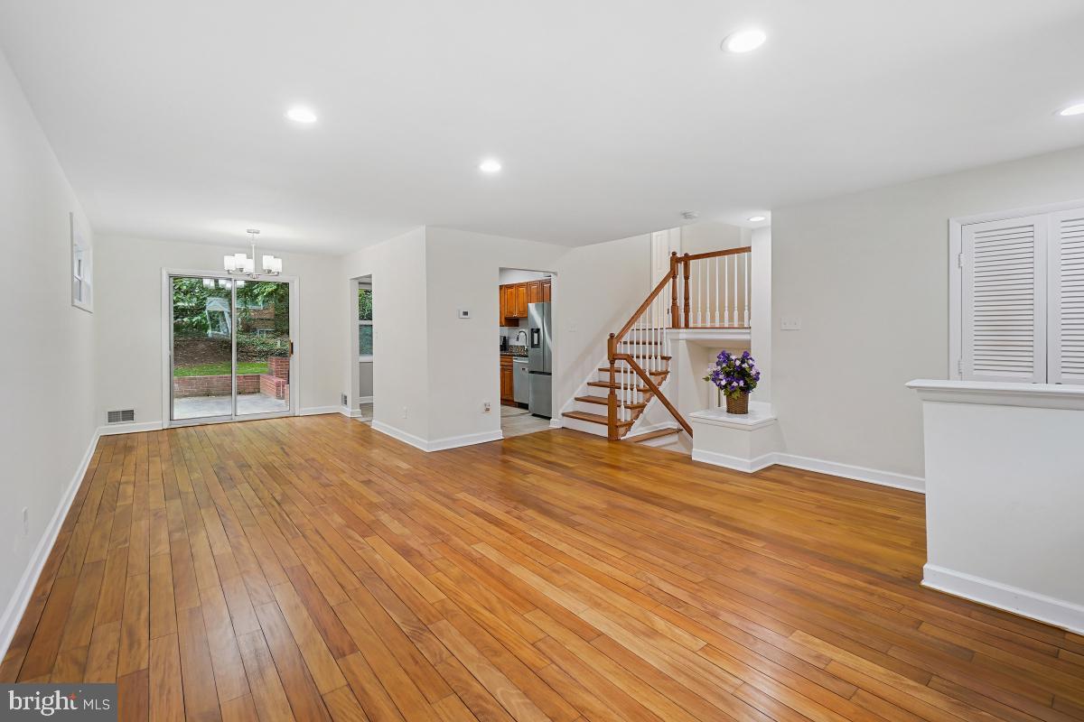 10307 Leslie Street Silver Spring, MD 20902 - Photo 8 of 46 a view of empty room with wooden floor and ceiling fan