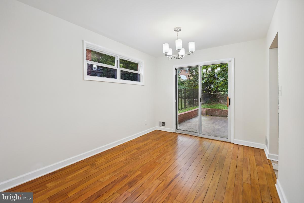 10307 Leslie Street Silver Spring, MD 20902 - Photo 9 of 46 an empty room with wooden floor and windows