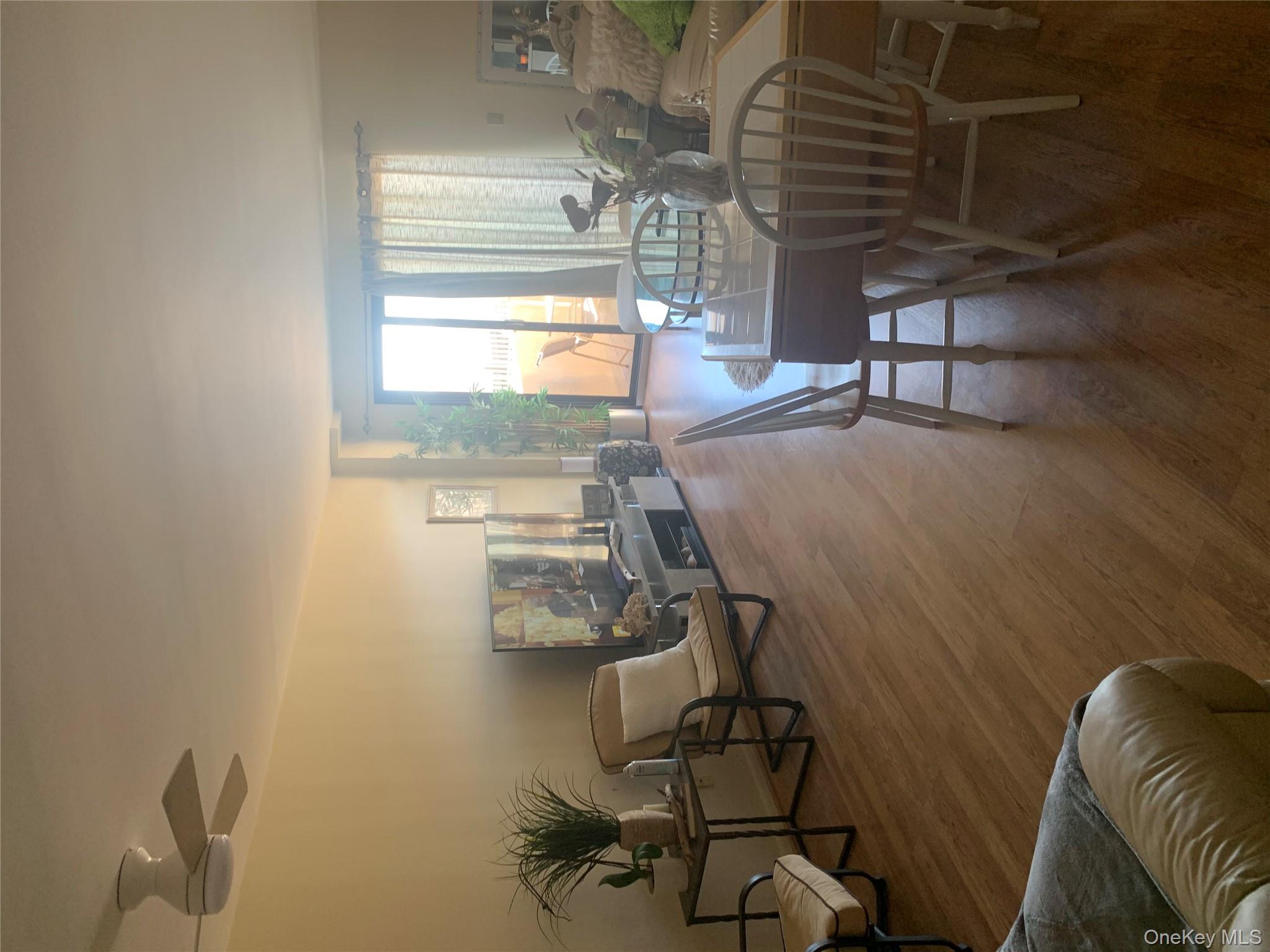 360 Shore Road, Unit 2H Long Beach, NY 11561 - Photo 2 of 13 Dining room with wood finished floors and ceiling fan