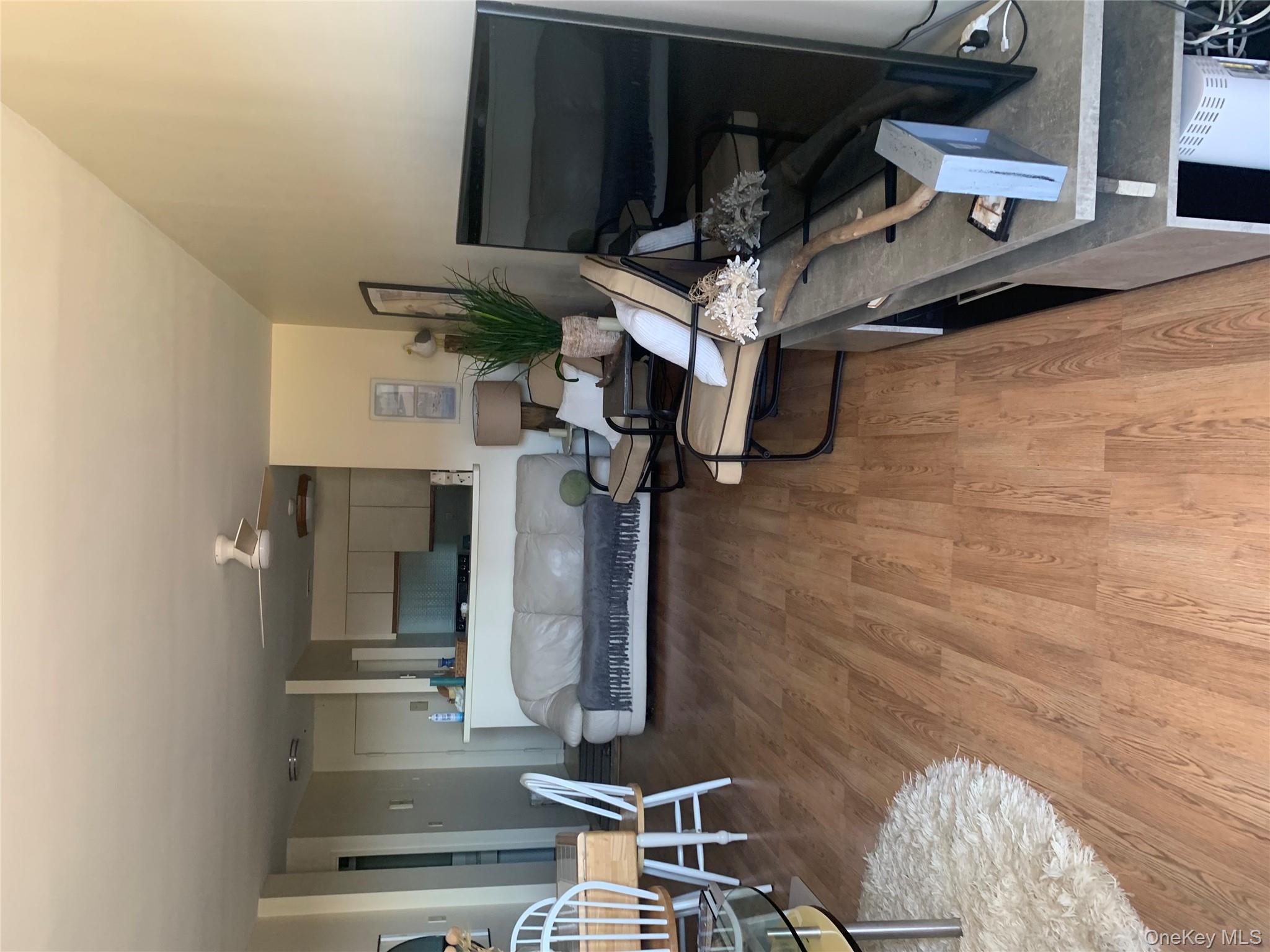 360 Shore Road, Unit 2H Long Beach, NY 11561 - Photo 7 of 13 Living room featuring light wood finished floors and ceiling fan