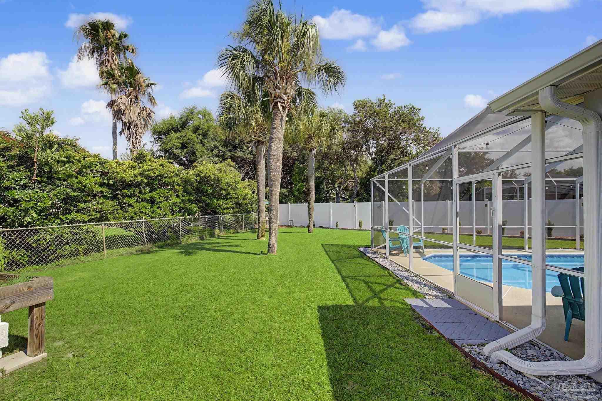 2005 Riviera Lane South Navarre, FL 32566 - Photo 66 of 70 a view of a house with swimming pool and a big yard