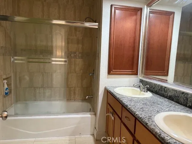 a bath tub sitting next to a bathroom sink