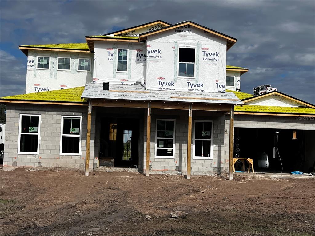 a view of a white house with large windows and a outdoor space