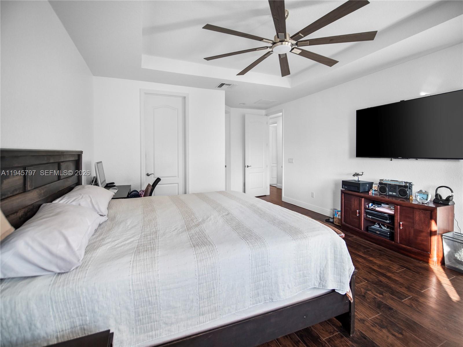 10552 Belfry Circle Orlando, FL 32832 - Photo 18 of 32 a bedroom with a bed and a flat screen tv