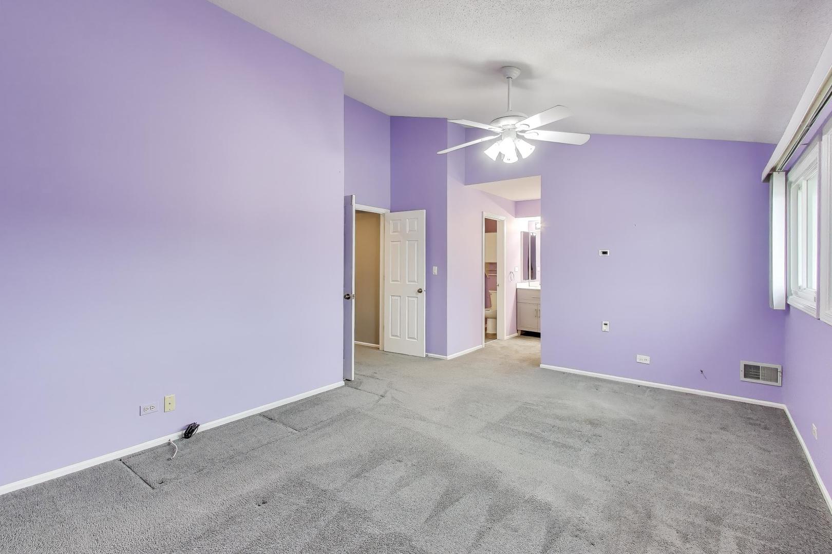 1096 Pine Tree Circle North Buffalo Grove, IL 60089 - Photo 12 of 25 an empty room with a ceiling fan and a window
