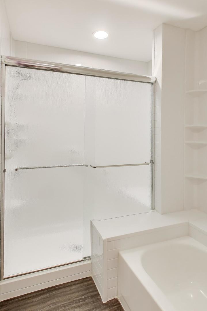 1096 Pine Tree Circle North Buffalo Grove, IL 60089 - Photo 15 of 25 a bathroom with a shower and a bath tub