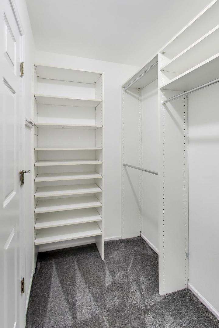 1096 Pine Tree Circle North Buffalo Grove, IL 60089 - Photo 16 of 25 a view of walk in closet with empty racks