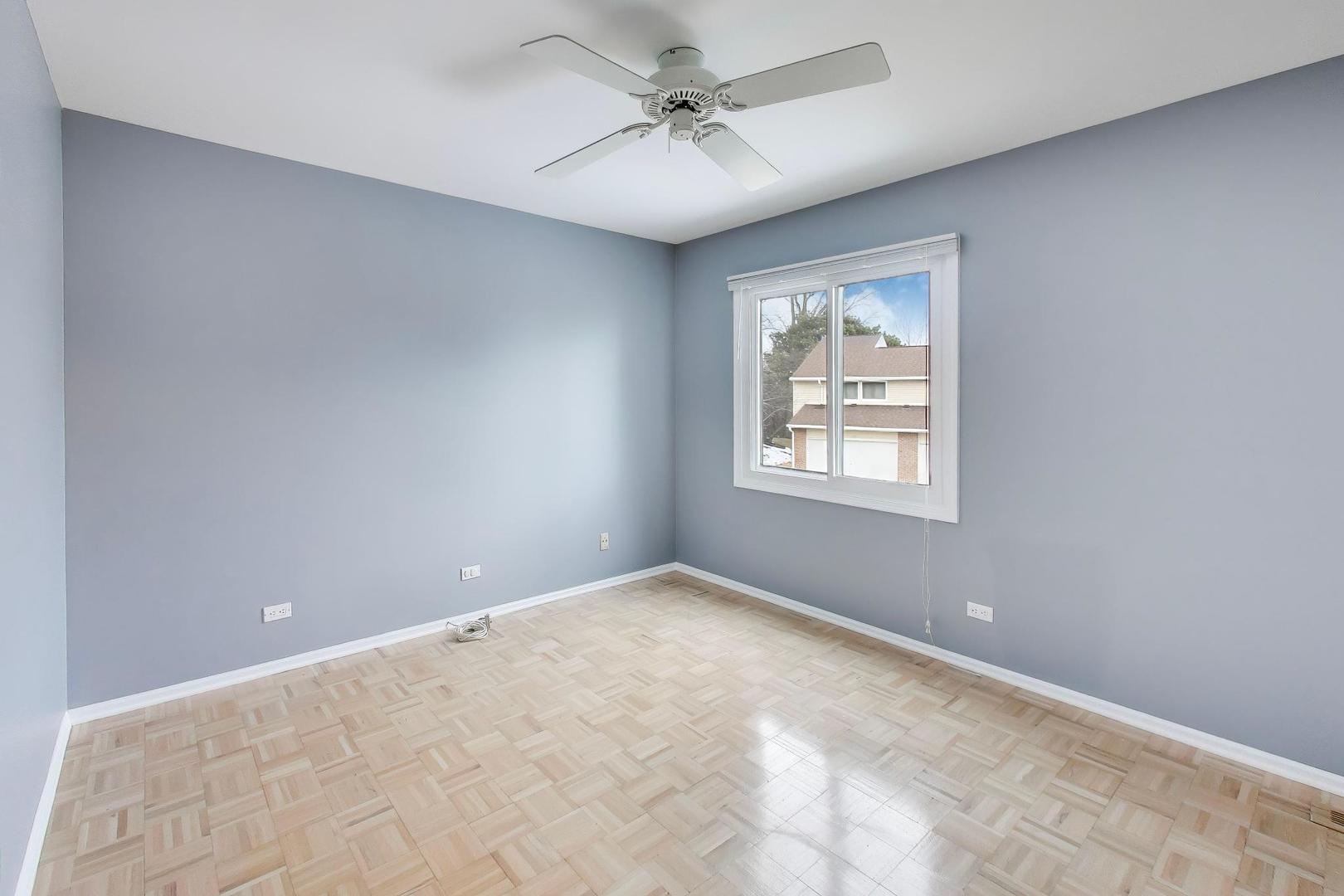 1096 Pine Tree Circle North Buffalo Grove, IL 60089 - Photo 17 of 25 an empty room with windows and ceiling fan