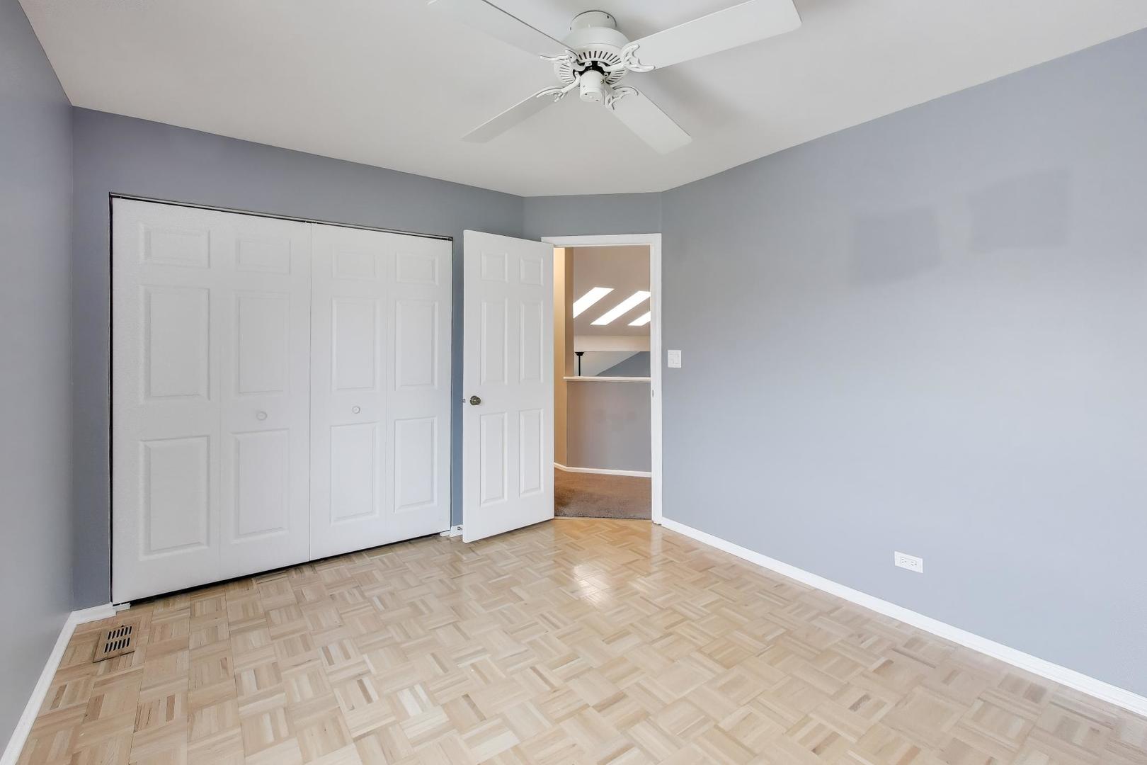 1096 Pine Tree Circle North Buffalo Grove, IL 60089 - Photo 18 of 25 an empty room with fan and entrance