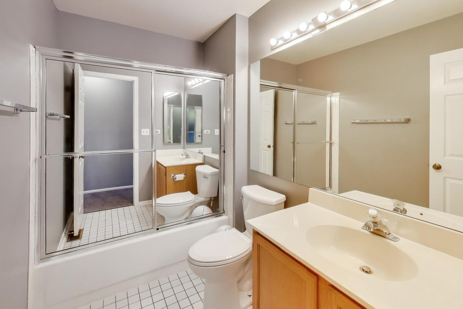 1096 Pine Tree Circle North Buffalo Grove, IL 60089 - Photo 21 of 25 a bathroom with a sink toilet and shower