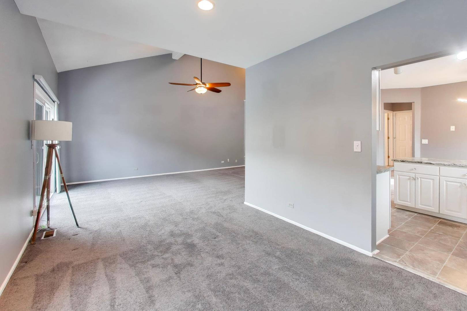1096 Pine Tree Circle North Buffalo Grove, IL 60089 - Photo 6 of 25 an empty room with a ceiling fan and entryway