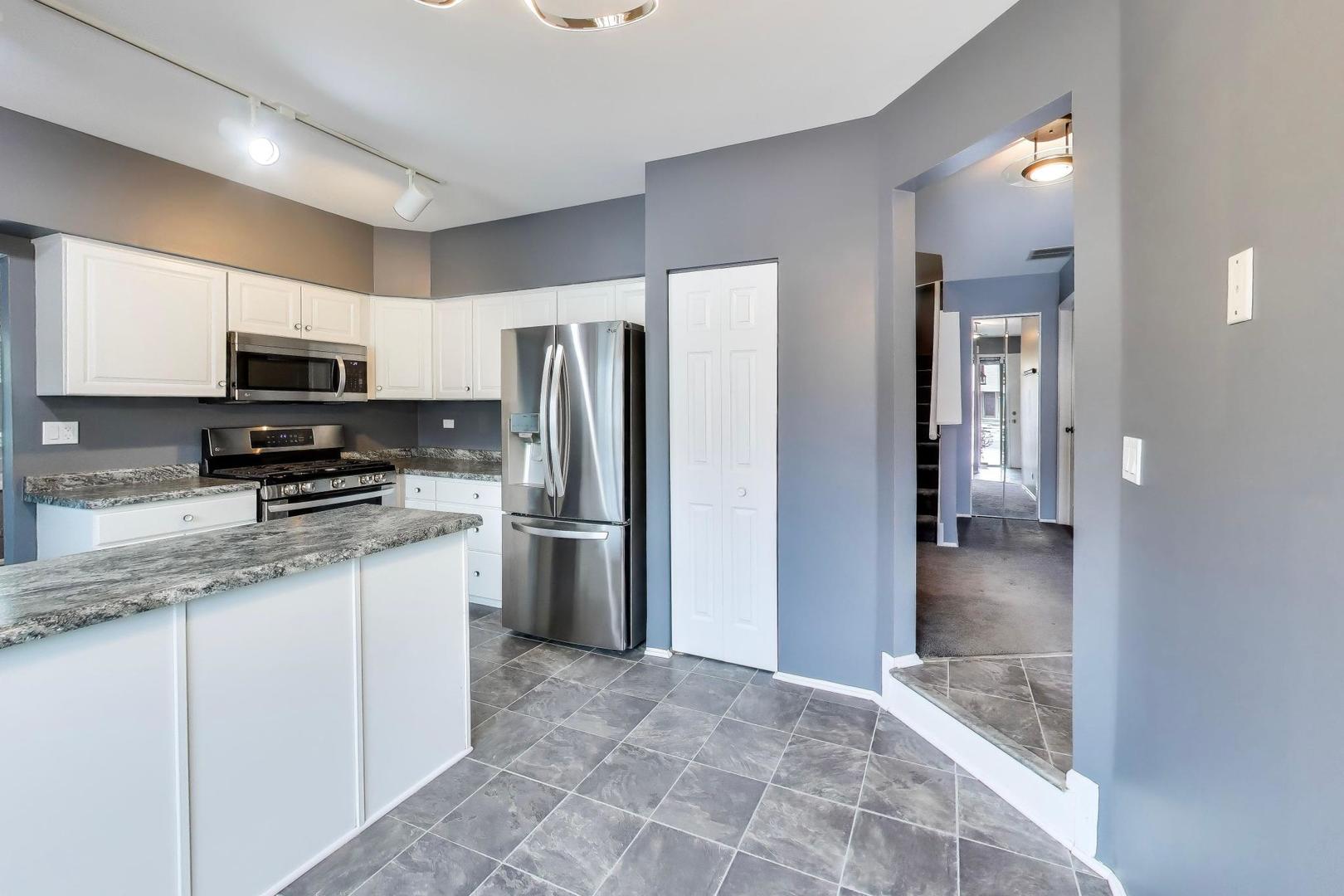 1096 Pine Tree Circle North Buffalo Grove, IL 60089 - Photo 10 of 25 a kitchen with a refrigerator and a sink
