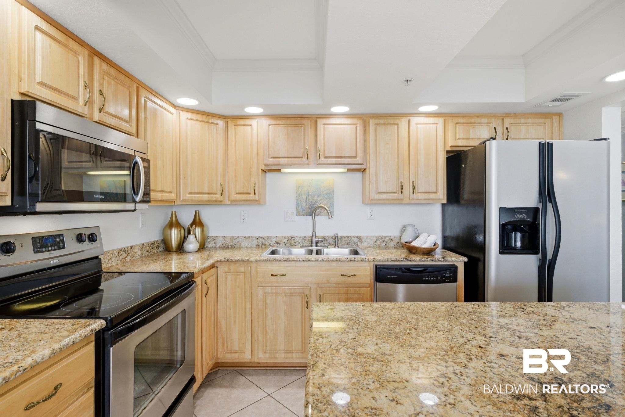 16284 Perdido Key Drive, Unit 912 Perdido Key, FL 32507 - Photo 27 of 49 Kitchen with stainless steel appliances, light wood finish cabinets, crown molding, recessed lighting, and light tile patterned floors
