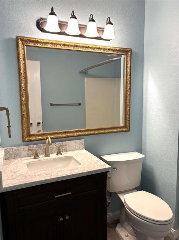 8201 Canoe Ridge Lane Denton, TX 76210 - Photo 13 of 25 a bathroom with a sink a toilet and mirror