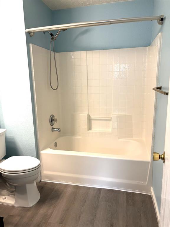 8201 Canoe Ridge Lane Denton, TX 76210 - Photo 15 of 25 a bathroom with a toilet and a bathtub