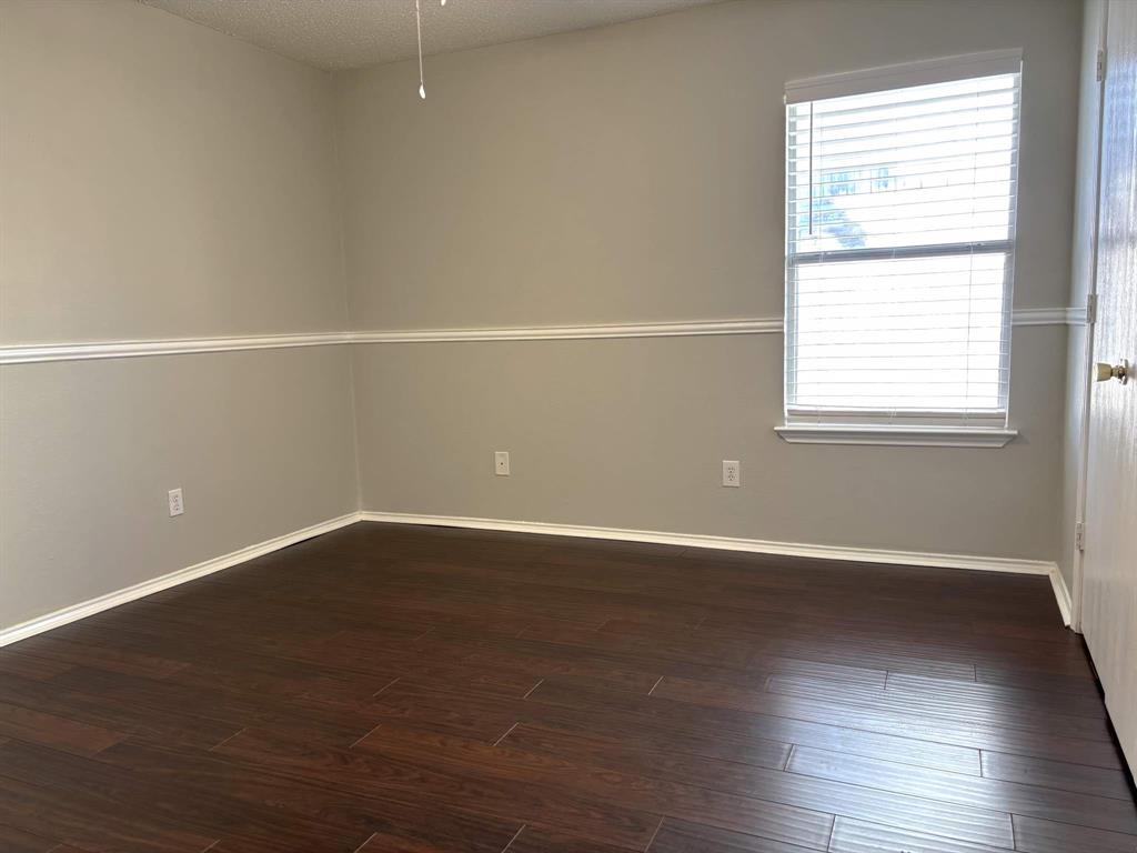 8201 Canoe Ridge Lane Denton, TX 76210 - Photo 18 of 25 an empty room with wooden floor and windows