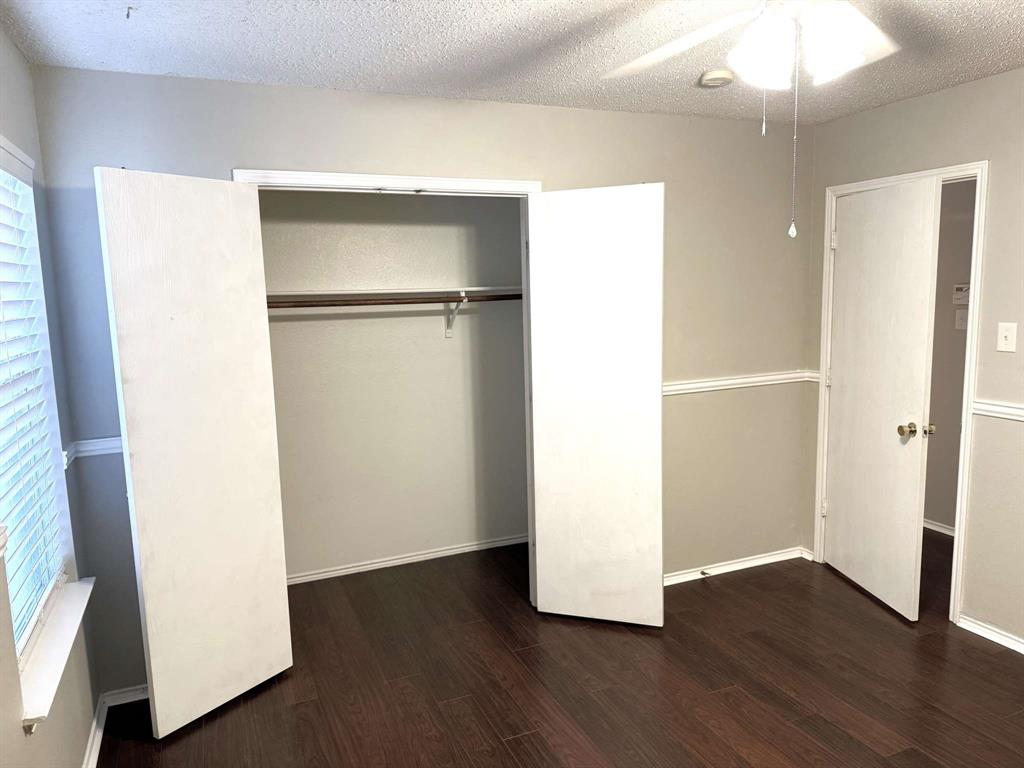 8201 Canoe Ridge Lane Denton, TX 76210 - Photo 19 of 25 a view of an empty room with wooden floor and a window