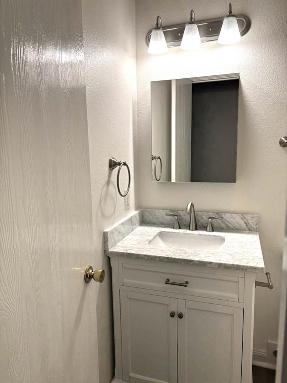 8201 Canoe Ridge Lane Denton, TX 76210 - Photo 21 of 25 a bathroom with a sink and a mirror