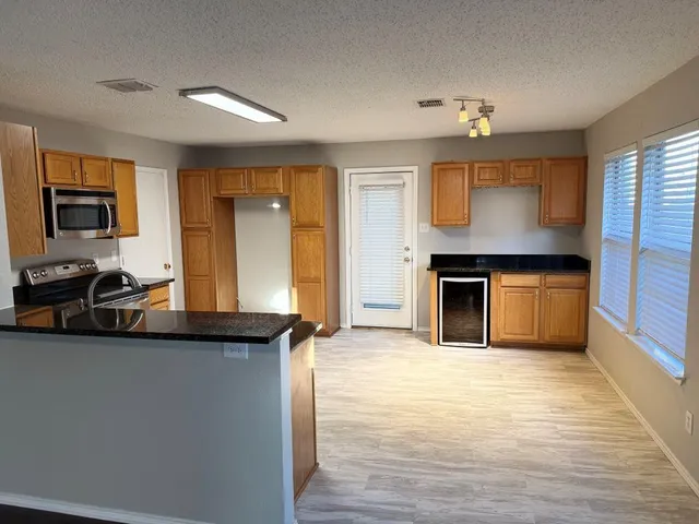 a view of a kitchen with a sink cabinets and a living room